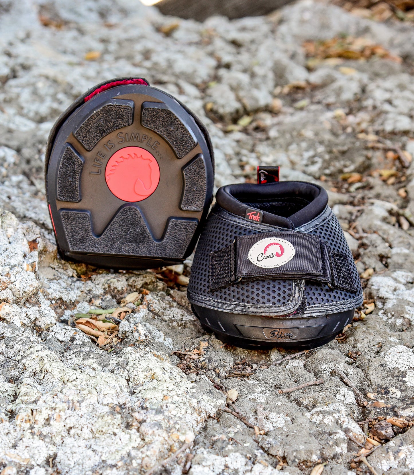 Two Black Cavallo Trek boots on rocky ground, showing the grip on the sole